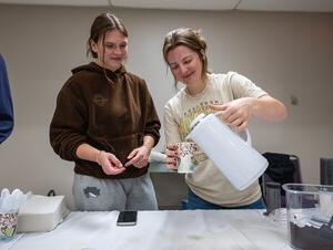 NWU students pour a cup of coffee.